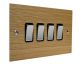 Solo Flat Plate Wood 4 Gang 2Way 10Amp Rocker Switch in  Oak with Polished Stainless Rocker and Black Trim